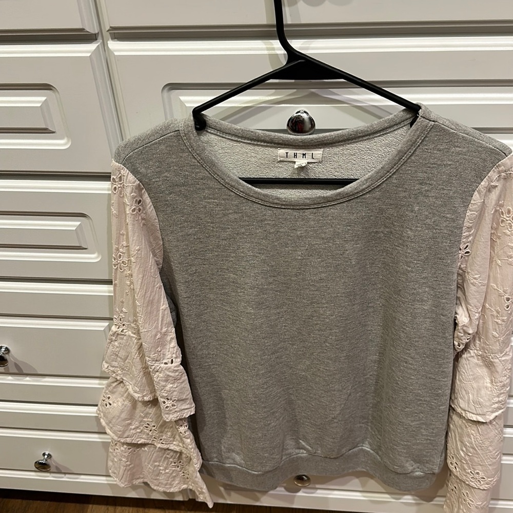 Gray light sweatshirt with eyelet ruffled off white sleeves never worn size s